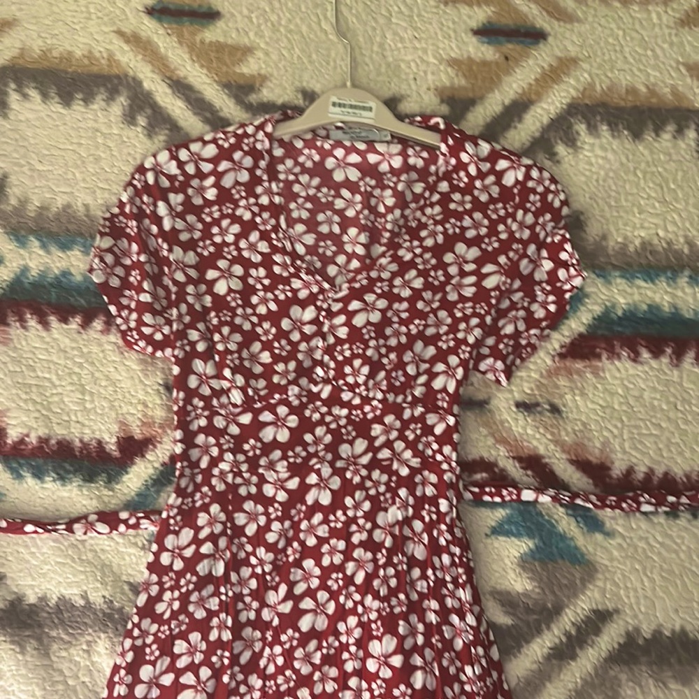 This is A Red Maxi Dress with a bow tie around the waist.